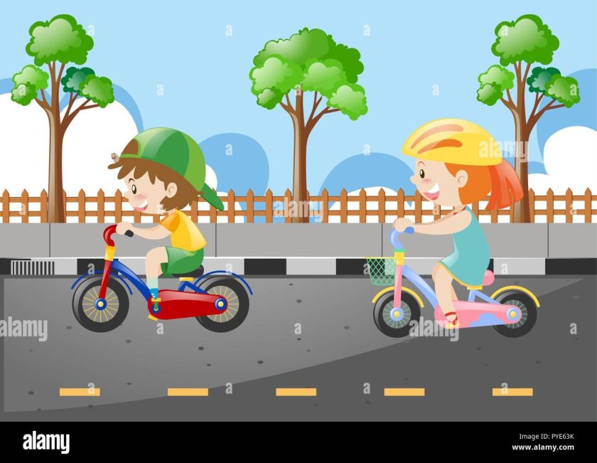 Дети катаются на дороге на велосипеде